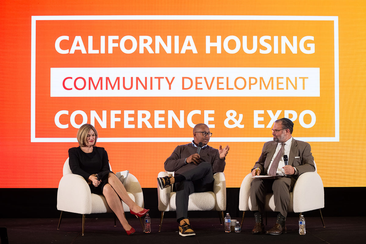 A panel on stage at the California Housing & Community Development Conference